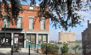 View on Ye Ole Tobacco shop from River Street Inn parking lot looking towards river with Westin Savannah in background.